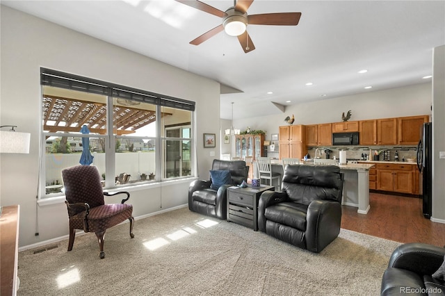 1210 Muskox St, Severance, CO 80550 - carpeted living area with ceiling fan and recessed lighting