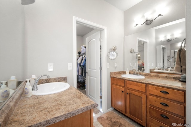 1210 Muskox St, Severance, CO 80550 - full bathroom with vanity, a spacious closet, and tile patterned floors