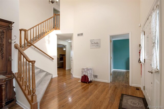 801 S 15th Ave, Brighton, CO 80601 - entryway with a towering ceiling, wood finished floors, stairs, and baseboards