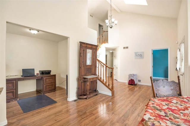 801 S 15th Ave, Brighton, CO 80601 - foyer featuring high vaulted ceiling, wood finished floors, stairway, a chandelier, and baseboards
