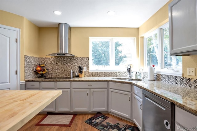 801 S 15th Ave, Brighton, CO 80601 - kitchen featuring stainless steel dishwasher, a sink, ventilation hood, wood finished floors, and backsplash