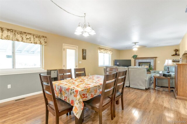 801 S 15th Ave, Brighton, CO 80601 - dining area with light wood-style flooring, a chandelier, baseboards, and a ceiling fan