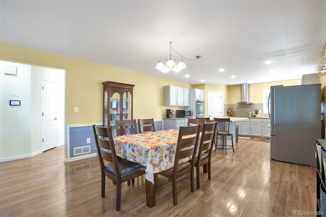 801 S 15th Ave, Brighton, CO 80601 - dining area with a chandelier, wood finished floors, recessed lighting, and baseboards