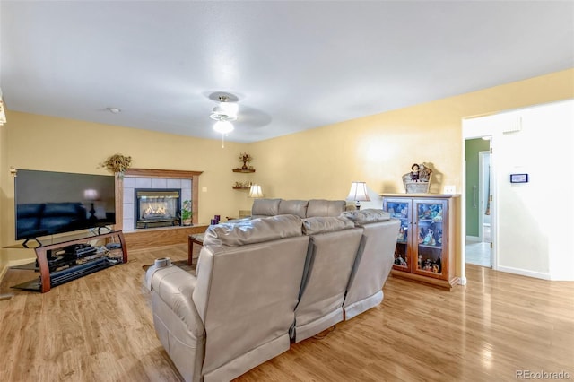 801 S 15th Ave, Brighton, CO 80601 - living room featuring a ceiling fan, wood finished floors, a tile fireplace, and baseboards
