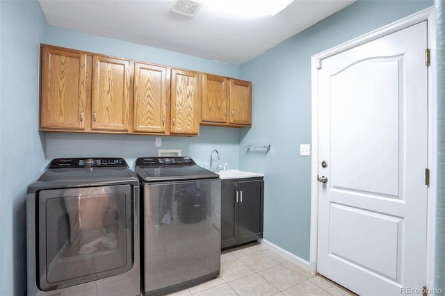 801 S 15th Ave, Brighton, CO 80601 - laundry room with cabinet space, washing machine and clothes dryer, light tile patterned floors, and baseboards
