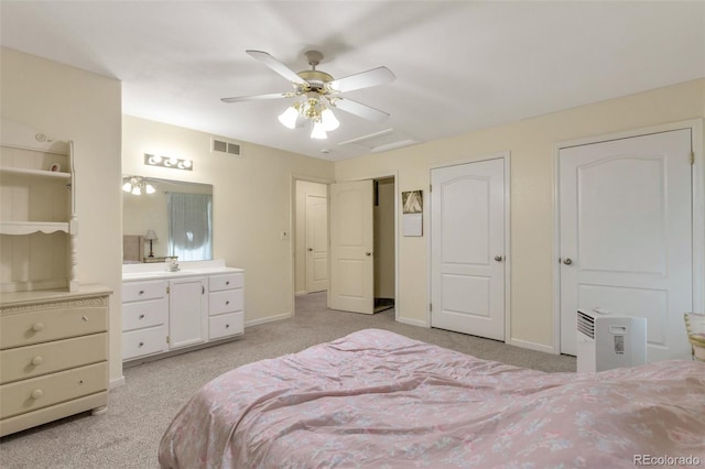 801 S 15th Ave, Brighton, CO 80601 - bedroom featuring light carpet, multiple closets, baseboards, ceiling fan, and a sink