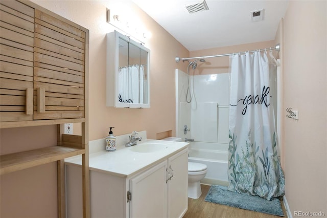 801 S 15th Ave, Brighton, CO 80601 - full bath featuring toilet, vanity, shower / tub combo with curtain, and wood finished floors