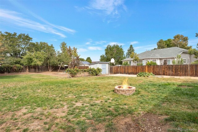 801 S 15th Ave, Brighton, CO 80601 - view of yard with an outdoor fire pit and a playground