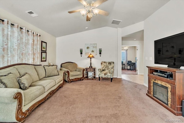 living room featuring ceiling fan, light colored carpet, and lofted ceiling