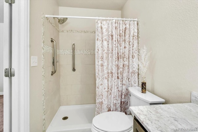 bathroom with toilet, vanity, and a shower with shower curtain