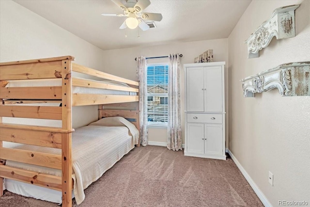 bedroom featuring ceiling fan and carpet