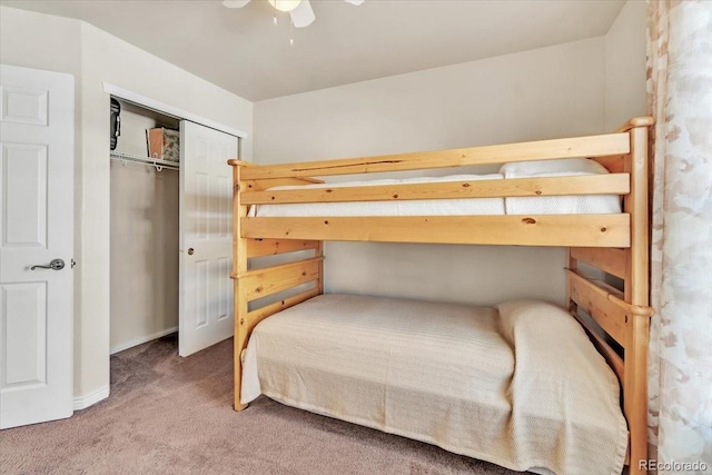 carpeted bedroom with ceiling fan and a closet