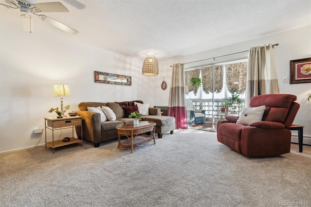 living room featuring ceiling fan, carpet, and a textured ceiling