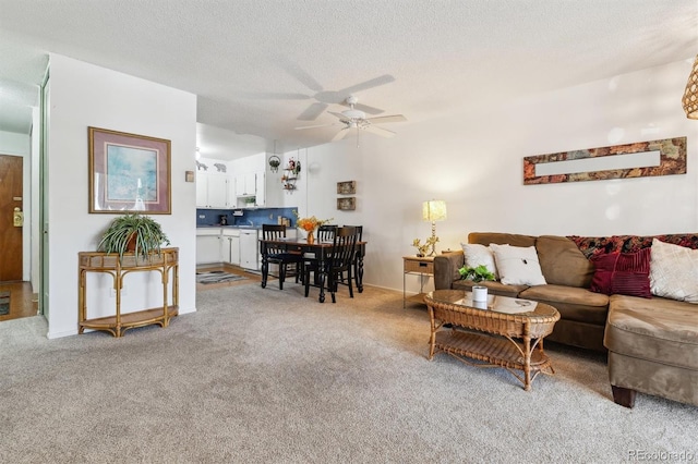 carpeted living room featuring ceiling fan and a textured ceiling