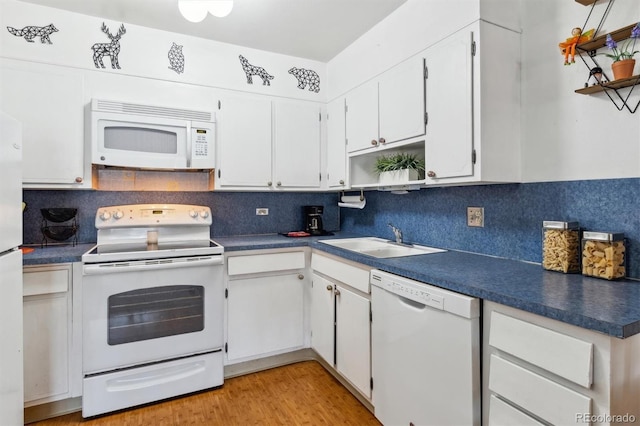 kitchen featuring sink, white cabinetry, white appliances, light hardwood / wood-style floors, and backsplash