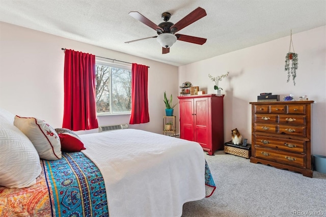 carpeted bedroom featuring a textured ceiling and ceiling fan