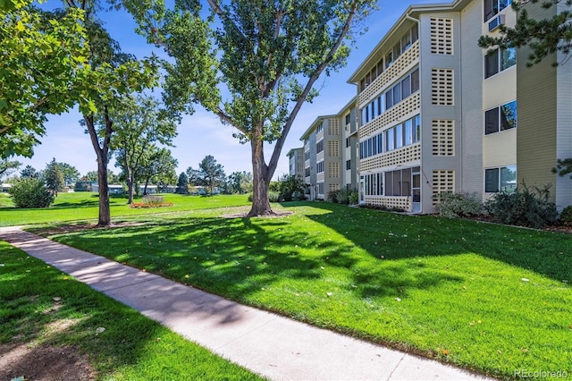 view of property's community with a lawn