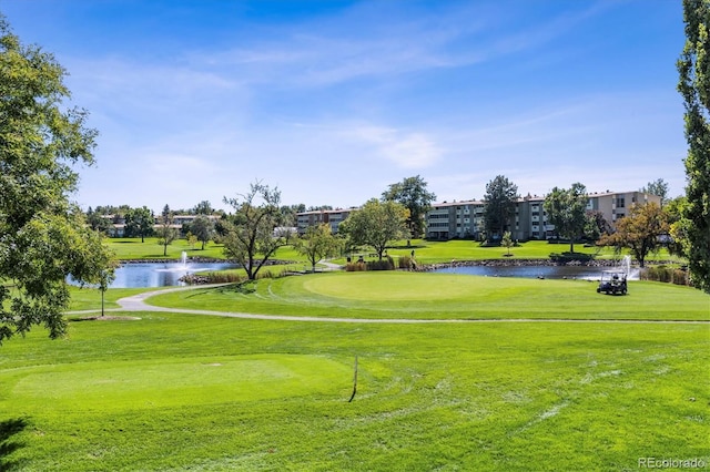 view of community with a lawn and a water view