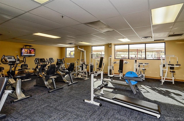 workout area with a paneled ceiling and carpet floors