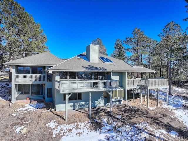 snow covered property featuring a deck