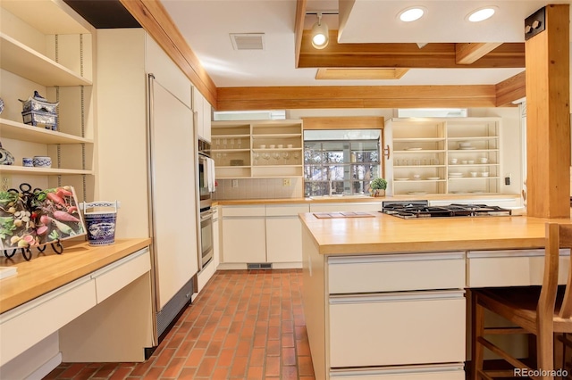 kitchen featuring wood counters, white cabinets, and appliances with stainless steel finishes