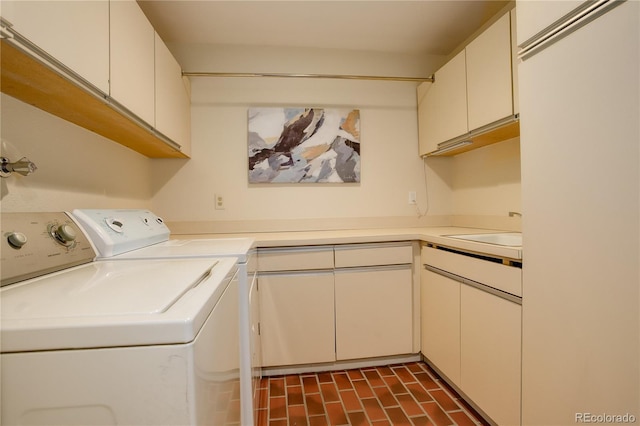 laundry room with cabinets, washer and clothes dryer, and sink