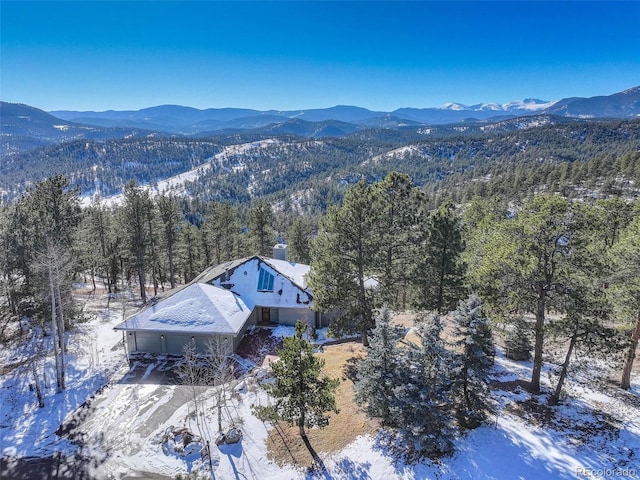 snowy aerial view featuring a mountain view