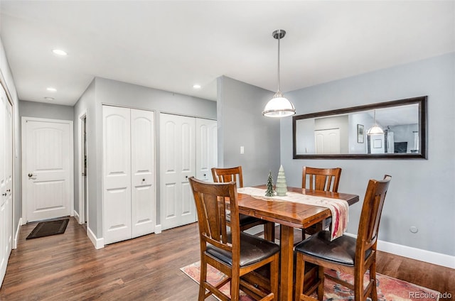 dining area with dark hardwood / wood-style floors