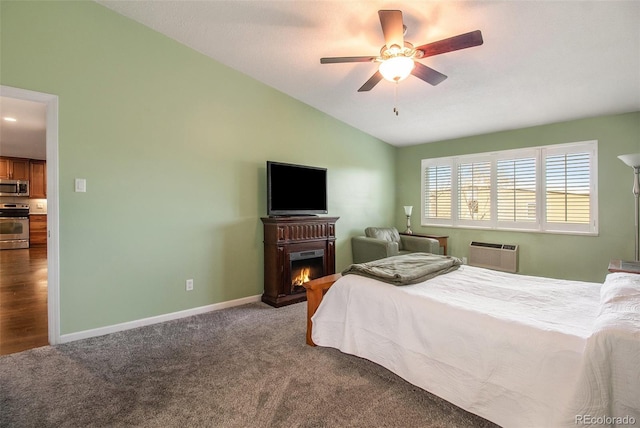 bedroom featuring vaulted ceiling, an AC wall unit, ceiling fan, and carpet