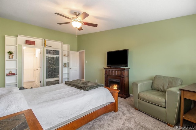 carpeted bedroom with ceiling fan and ensuite bathroom