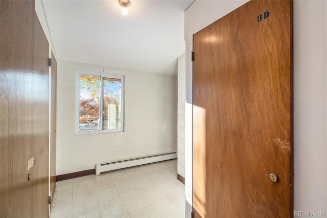 interior space featuring a baseboard radiator and lofted ceiling