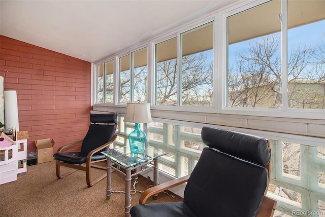 sunroom / solarium featuring lofted ceiling