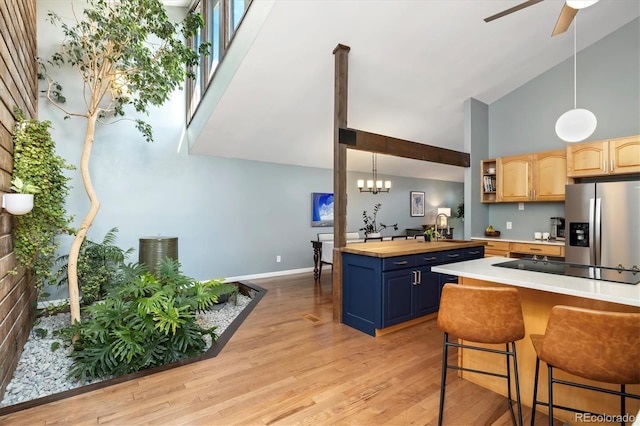 6305 W 6th Ave Unit C12, Lakewood, CO 80214 - kitchen featuring stainless steel fridge, high vaulted ceiling, black electric stovetop, light wood-style floors, and ceiling fan