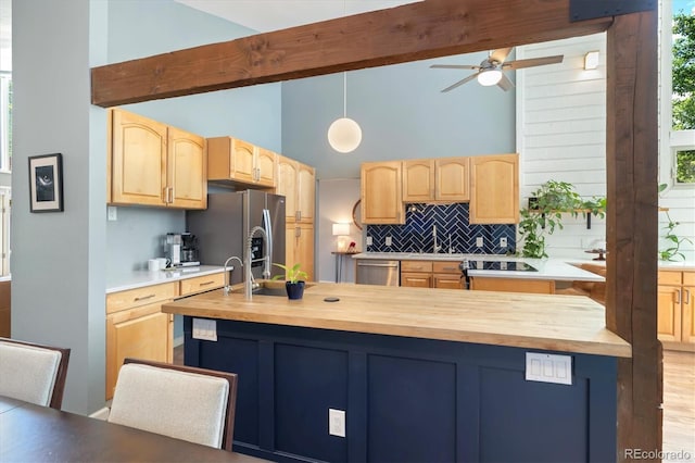 6305 W 6th Ave Unit C12, Lakewood, CO 80214 - kitchen featuring stainless steel appliances, butcher block counters, light brown cabinets, and high vaulted ceiling