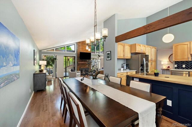 6305 W 6th Ave Unit C12, Lakewood, CO 80214 - dining room with high vaulted ceiling, a chandelier, and light wood-style flooring