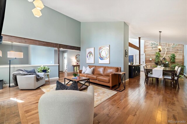 6305 W 6th Ave Unit C12, Lakewood, CO 80214 - living area with wood-type flooring and a towering ceiling