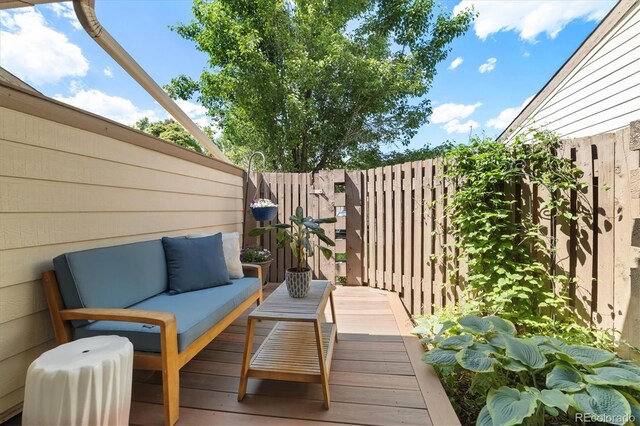 6305 W 6th Ave Unit C12, Lakewood, CO 80214 - wooden deck with a fenced backyard and an outdoor hangout area