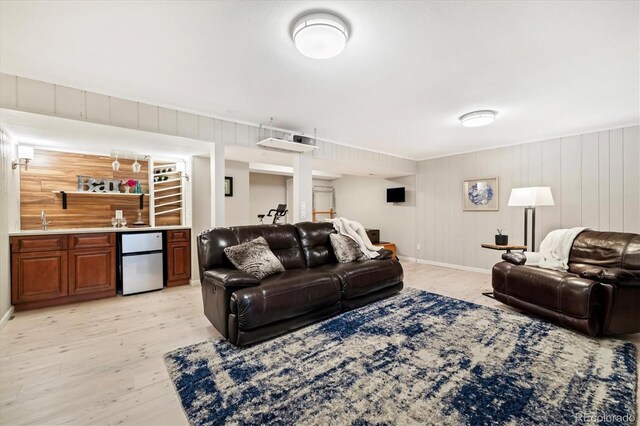 6305 W 6th Ave Unit C12, Lakewood, CO 80214 - living room with wet bar, light wood-type flooring, and wood walls