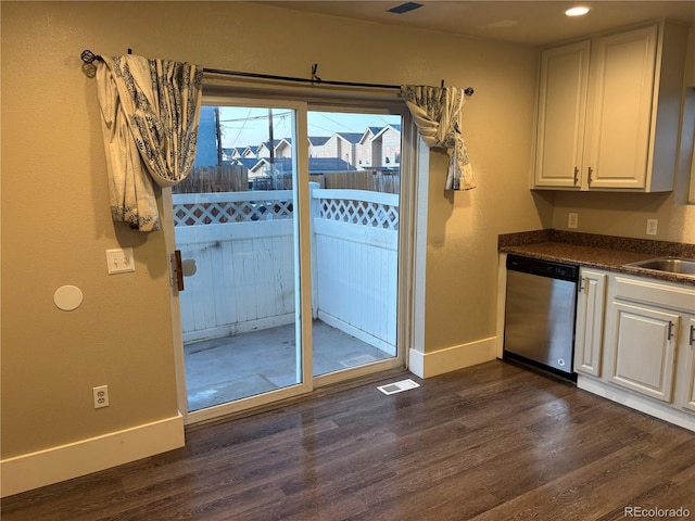 1222 Yosemite St, Denver, CO 80220 - kitchen featuring dishwasher, dark wood finished floors, dark countertops, white cabinets, and recessed lighting
