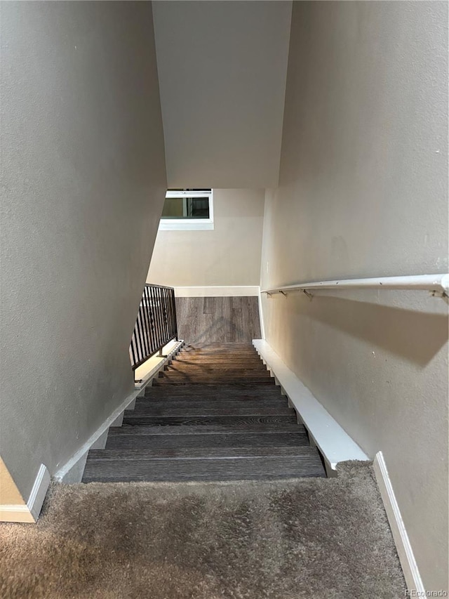 1222 Yosemite St, Denver, CO 80220 - stairs with a textured wall and carpet floors