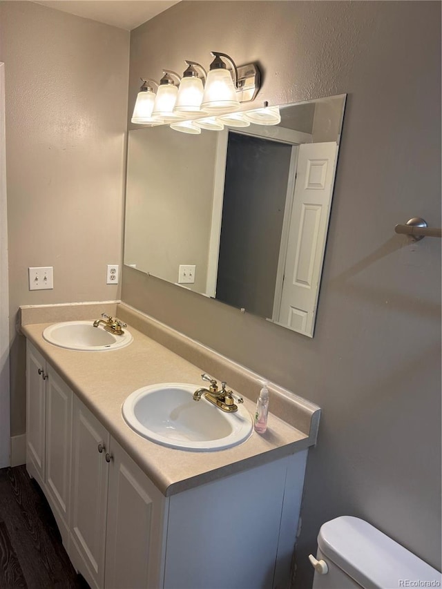 1222 Yosemite St, Denver, CO 80220 - bathroom with double vanity and wood finished floors