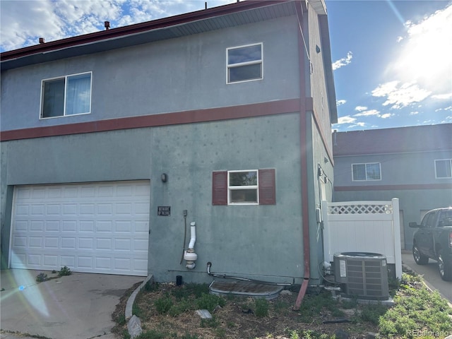 1222 Yosemite St, Denver, CO 80220 - rear view of house featuring a garage and driveway