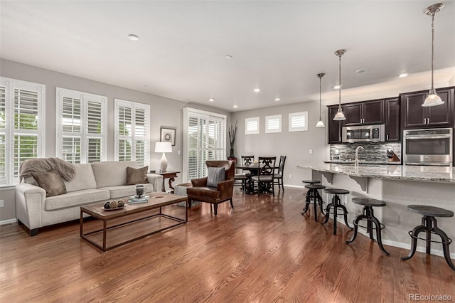 7991 Heritage Dr, Thornton, CO 80602 - living room with baseboards, recessed lighting, and dark wood-type flooring