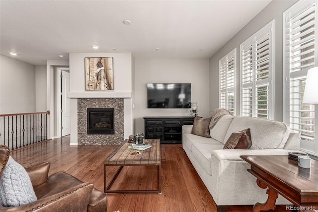 7991 Heritage Dr, Thornton, CO 80602 - living area with wood finished floors, a tiled fireplace, and recessed lighting