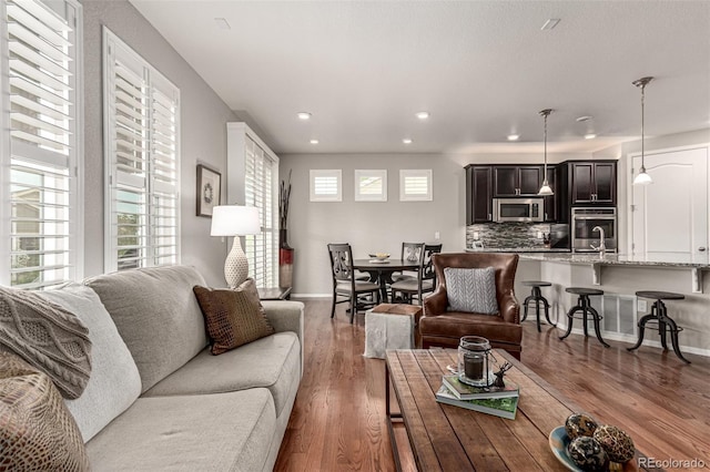 7991 Heritage Dr, Thornton, CO 80602 - living area featuring recessed lighting, wood finished floors, and baseboards