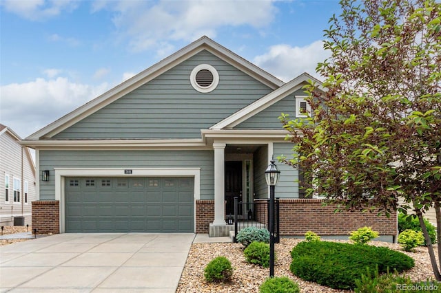 7991 Heritage Dr, Thornton, CO 80602 - view of front of home with brick siding, concrete driveway, and an attached garage