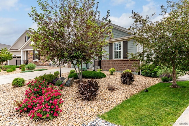 7991 Heritage Dr, Thornton, CO 80602 - obstructed view of property with brick siding, concrete driveway, and a garage