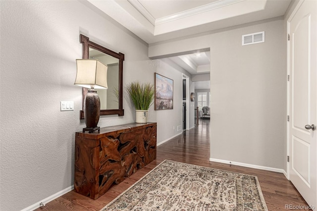 7991 Heritage Dr, Thornton, CO 80602 - corridor featuring a tray ceiling, wood finished floors, ornamental molding, and baseboards