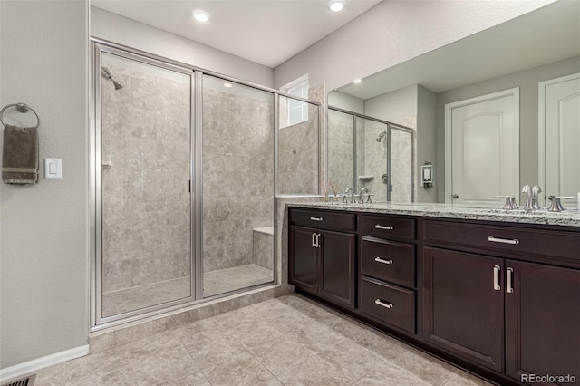 7991 Heritage Dr, Thornton, CO 80602 - bathroom featuring a shower stall, double vanity, and recessed lighting
