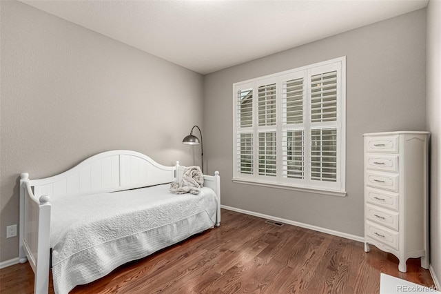 7991 Heritage Dr, Thornton, CO 80602 - bedroom with wood finished floors, baseboards, and multiple windows